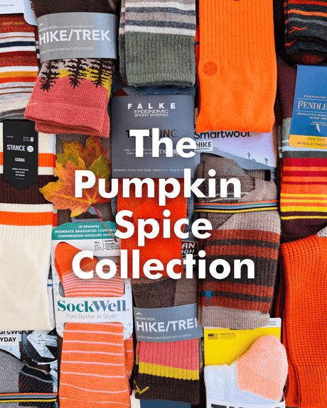 Collection of colorful socks with brand labels, featuring text 'The Pumpkin Spice Collection'.